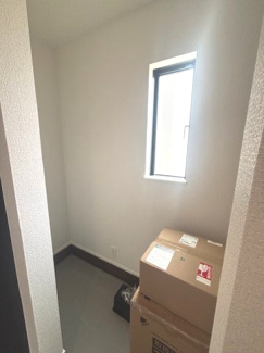 【玄関】 | 東広島市八本松飯田6丁目（全2区画）1号棟　 | 玄関横には、ベビーカーやアウトドア用品の保管にも便利なシューズインクローゼットを配置。小窓を設けているため、湿気やにおいがこもりにくく、自然光が入る明るい収納スペースとなっています。