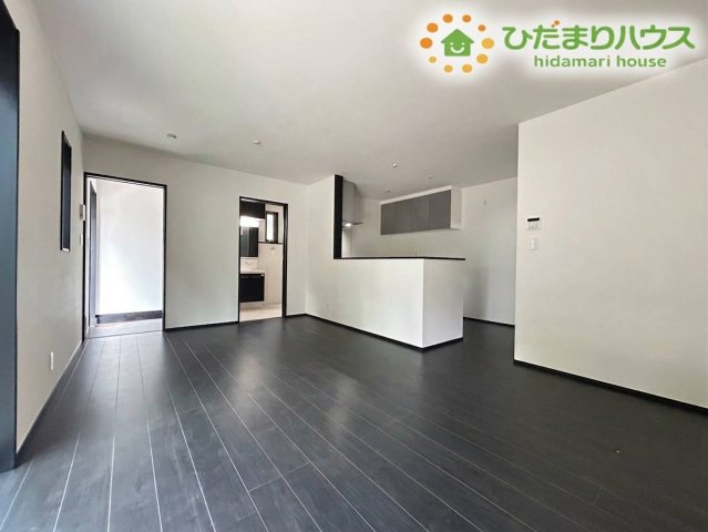 東松山市小松原町　新築一戸建て　01の居間・リビング|ダークトーンの床材が空間を引き締めるおしゃれなLDKです！対面キッチンから部屋全体を見渡せるためお料理中もご家族との会話が弾みます♪広々としたスペースでゆったり団らんを楽しめますね！