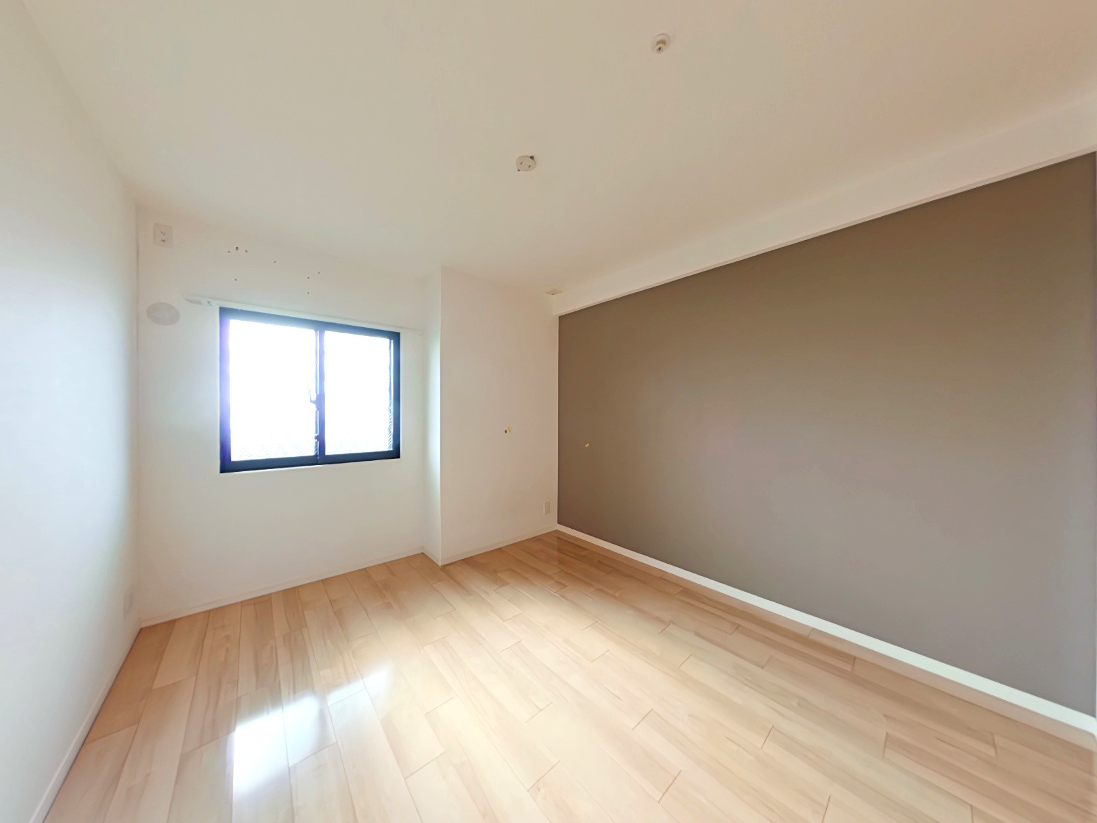 アルファステイツ野田Ⅲの洋室|北西側の洋室になります。白色のクロスと明るめの木目調にグレーのアクセントクロスを取り入れることでおしゃれに演出されております。お部屋の広さは6.2帖ございます。