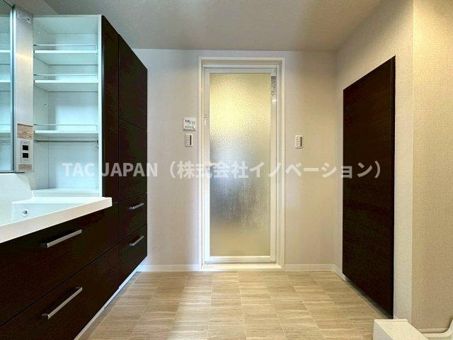 フラッツ上野入谷南公園の洗面所|大型の洗濯機を置いても余裕が感じられる脱衣スペースにはお洒落な洗面ユニットを制作。着替えやタオル、洗剤の買い置きなどリネン庫の使い方はお客様しだい。