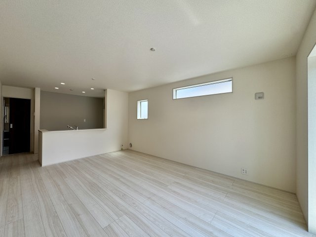 白鳥町 全3棟 2号棟の居間・リビング|キッチンの背面がアクセントクロスになっています。