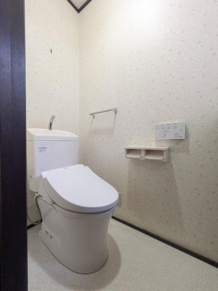 新明治5丁目　戸建のトイレ|明るい雰囲気の収納付きトイレです。壁には操作パネルが設置されています空間にゆとりがあり機能性を感じます。シンプルで使いやすいです。