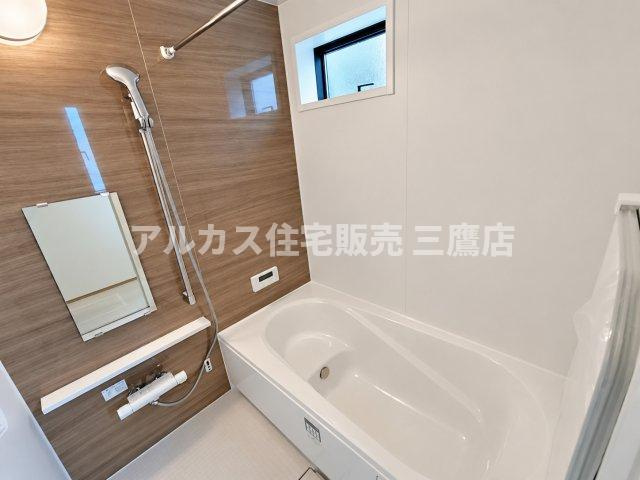 京王線 柴崎駅 3分 新築戸建 調布市菊野台2丁目の浴室|木目調のアクセントパネルが癒やしの空間を演出するバスルーム。小窓付きで自然換気も行え、衛生的に保てます。