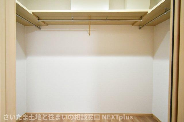 蓮田市閏戸　中古戸建の収納|2帖の広さを確保した収納力のあるウォークインクローゼット。枕棚とハンガーパイプを三面に配し、衣類から季節家電まで整然と収まります。全室床暖房仕様で、湿気がこもりにくいのも嬉しいポイントです。