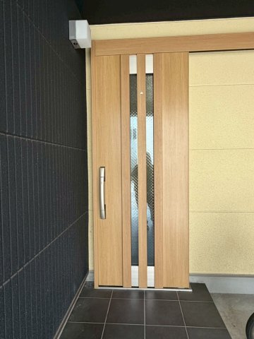旭区今市１丁目中古戸建の玄関|中央に二本の採光ラインが並ぶ玄関ドア。シックな外壁と明るい木目の組み合わせがおしゃれです。