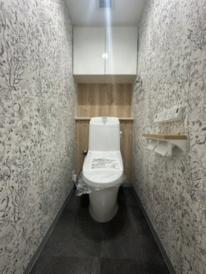 【トイレ】 | ガーデンハウス千里・古江台 | 温水洗浄便座付のトイレで、冬の寒い時期でも快適！吊戸棚付きで、予備のペーパー類も問題なく収納できます。