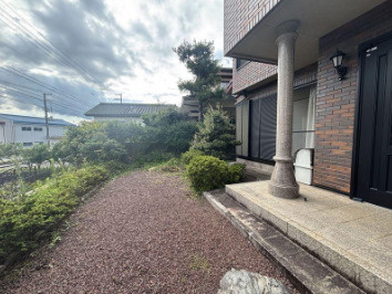 【並列駐車3台可】高知市大津甲　中古一戸建ての庭|プライバシーに配慮された、奥行きのある玄関アプローチ。