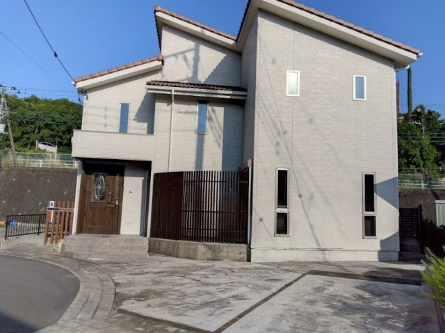売中古戸建　三島市北沢の外観|南欧風の瓦屋根とスタイリッシュな外観が目を引く戸建てです。前面には並列駐車可能なゆとりのカースペースを完備しています。目隠しフェンスがプライバシーを守り、開放感ある暮らしを叶えます。