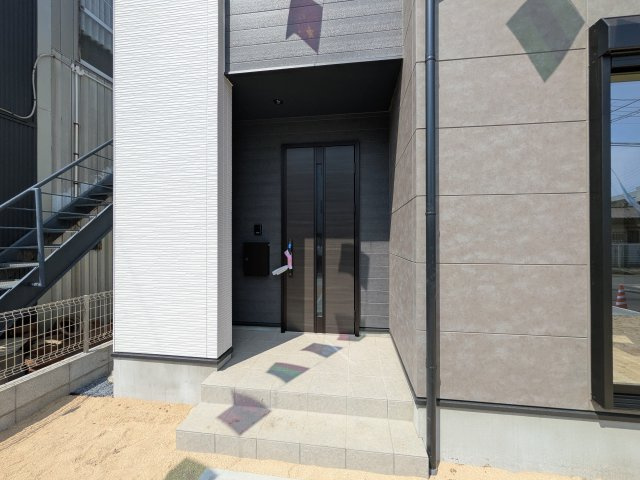 水戸市渡里町　4期　新築戸建ての玄関|お洒落な玄関ドアと洗練された外壁デザイン。家の顔にふさわしい上質な佇まいで、ご家族やお客様を迎えます。