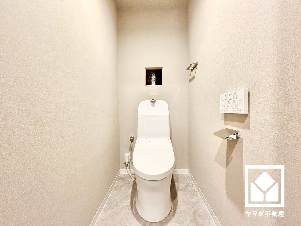 西宮マリナパークシティ・桜のまち5番館のトイレ|明るく清潔感溢れるトイレです。温水洗浄便座付きで、季節を問わずいつでも温かい便座をお使いいただけます。トイレットペーパーのストックや消耗品置き場などとしてお使いいただける吊戸棚もございます。