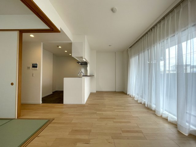 玄関ポーチがあるコトによってプライバシー得やすい角部屋に。オープンタイプの和室も使い勝手が良さそうで、うたた寝注意の『ナイスサンソレイユ横濱鶴ヶ峰』リノベーションの居間・リビング|ゆったりとしたリビングです