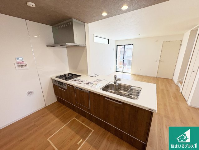箕面市新稲　第1期　新築一戸建てのキッチン|リビングと統一感があり、使い勝手のいいキッチン。広々としているので、二人並んで作業が出来ちゃいます。お子様と一緒に色々なお料理に挑戦できるスペースがあります。