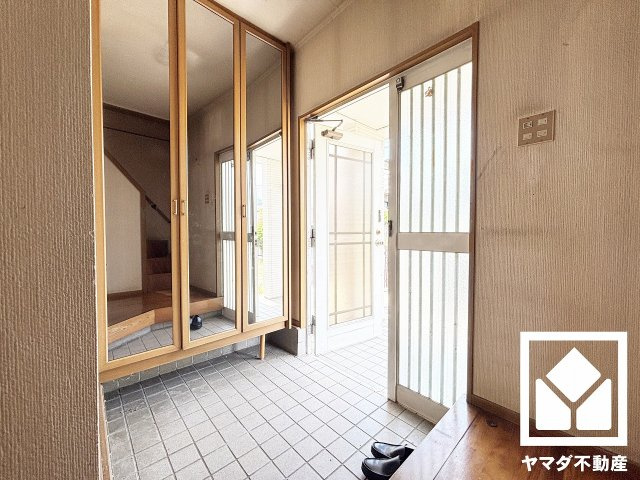 西宮市北六甲台３丁目の玄関|玄関は余裕をもたせた広さになっているので、家族が揃って靴を選んだりお出かけの準備を整えたりすることができます。お出かけの前のチェックにも便利な鏡付きです。