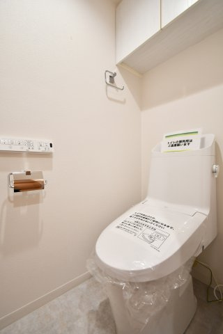 与野パーク・ホームズのトイレ|トイレ：奥行きにゆとりがあり、圧迫感の少ないトイレスペース。吊戸棚付きで、トイレットペーパーなどの備品補充も楽々行えます。掃除用具をしまうと清潔感も消す事ができ、イマドキなお部屋にできます。