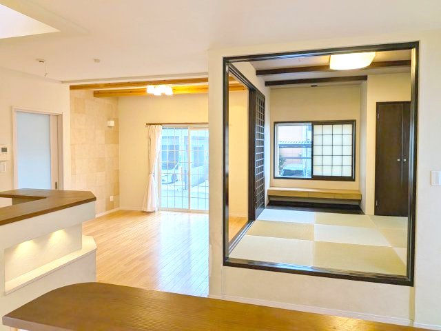 貝塚市東山１丁目戸建の居間・リビング|LDK隣の和室が窓側にカウンターと足を下せるスペースがあります。そのスペースには蓋がありますので、蓋をすればその分のスペースも広く使えます。