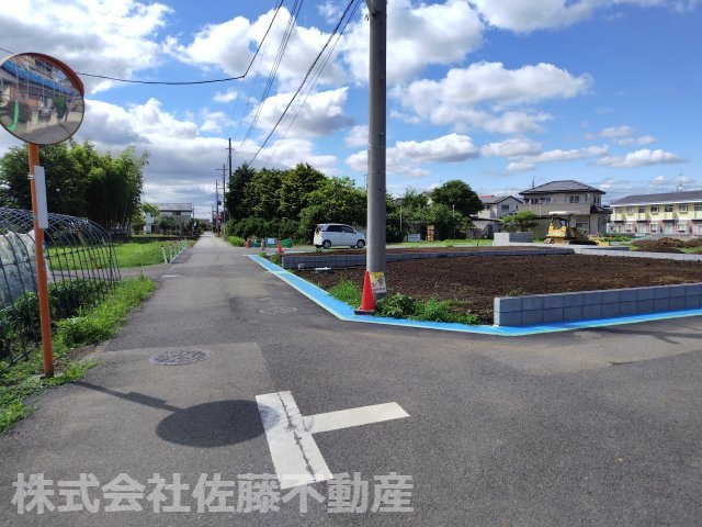 【分譲地】北鴻巣駅14分・46坪の整形角地の前面道路含む現地写真|2026年6月21日 14:30頃撮影。E区画の南西側接道と南東側接道の交差部分から北西方向へ撮影した鴻巣市道の様子。右手にE区画が見えます。
