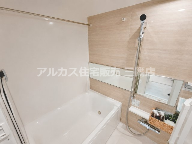 レーヴステージ府中緑町の浴室|木目調パネルがやわらかな印象を添える浴室。横長ミラーとシャワーを備えています。