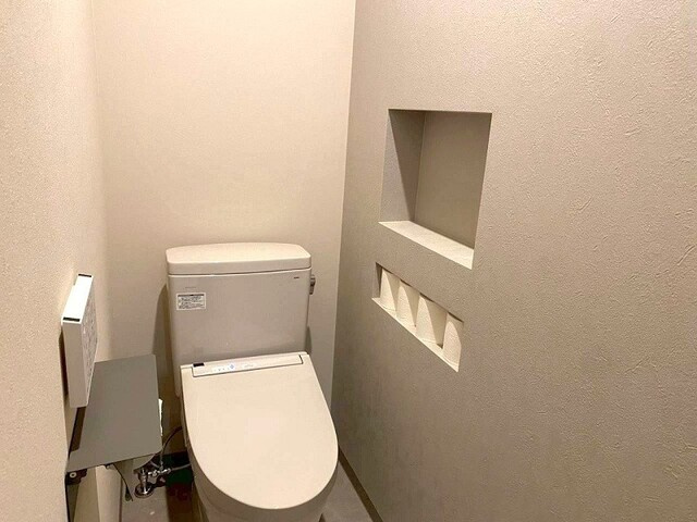 「大型ファミクロ完備」高知市南万々　中古一戸建てのトイレ|トイレットペーパーも美しく収まる、ニッチ収納付きの清潔なトイレ。