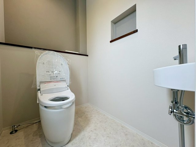 「高台」高知市瀬戸東町　新築戸建のトイレ|独立した手洗い器付きで使い勝手◎タンクレストイレ風のすっきりしたデザインとニッチ収納が魅力です。