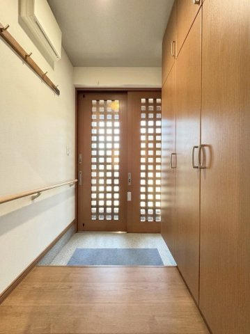 富丘3条4丁目二世帯住宅の玄関|1階の玄関スペースは外からの光を取り入れられるデザイン性の高い引戸タイプ。安心の手すり付きです♪