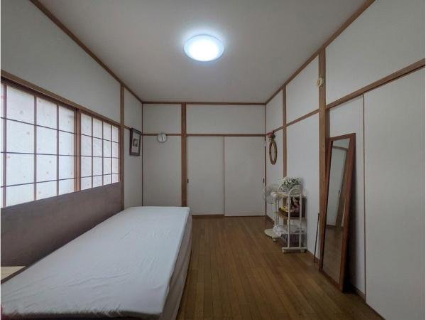 皆春　戸建ての寝室|和の雰囲気が漂う寝室です。シンプルな内装でお手入れがしやすい空間です。大きな窓から自然光が入り明るい印象です。収納スペースも備わっています。全体的に落ち着いた設計です。