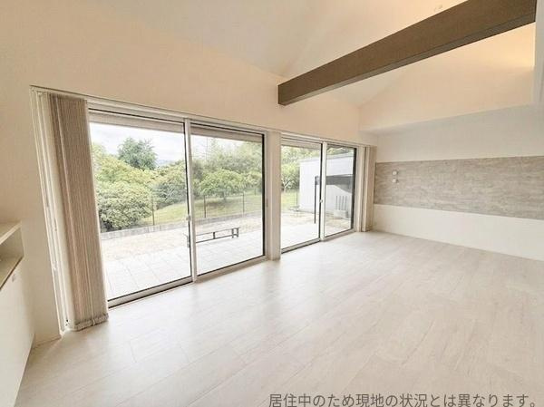 丹生中古の居間・リビング|リビングは大きな窓から光がたっぷりと入り開放的な空間が広がっています。明るいフローリングが室内をすっきりと見せ落ち着いた雰囲気を演出しています。
