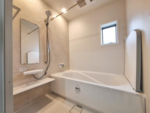 森1号新築建売住宅の浴室|清潔感のあるバスルームは明るい壁面と大きめの浴槽が特徴です。使い勝手の良いカウンターとシャワーも設置されています。小窓が設けられており自然光を感じられます。