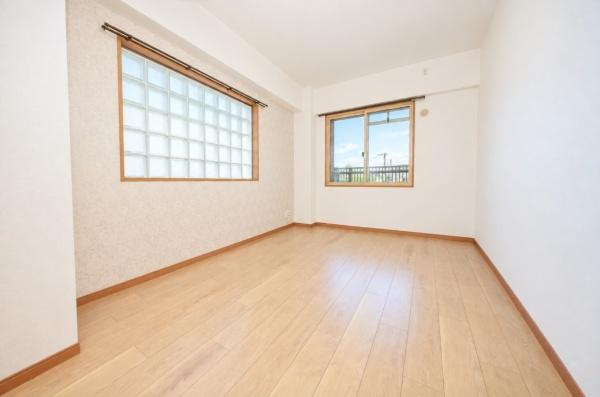 グラン コープ枚方 香里ケ丘　中古 マンションの寝室|やわらかな木目の床と、ガラスブロックの窓が印象的な洋室。2面の窓が明るさと開放感を演出し、心地よいプライベート空間に。寝室や子ども部屋、書斎など多彩な使い方が楽しめます。