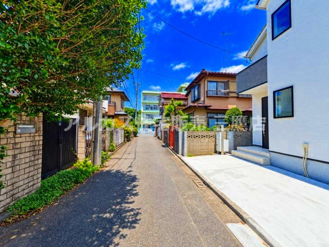 小平市仲町　西武新宿線　小平駅　新築戸建の前面道路含む現地写真|青空に映えるスタイリッシュでモダンな外観。敷地内にはお車の駐車スペースも確保されており、スムーズに出し入れが行えます。