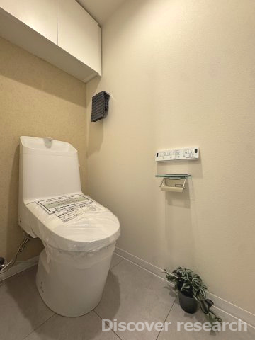 プレシス多摩永山レヴィエのトイレ|白を基調とした落ち着きのあるトイレです。上部には棚がありペーパーなどを収納しておくことができそうです。