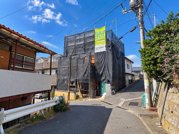 横浜市保土ケ谷区仏向西の新築一戸建の前面道路含む現地写真|現地正面から撮影した外観写真。現在は建築工事中ですが、建物の配置や前面道路との位置関係が分かりやすい一枚です。陽当たりや周辺環境も含め、完成前だからこそ確認できる現地の状況をご覧いただけます。
