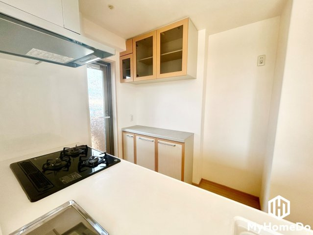 ローレルコート志賀本通のキッチン|お部屋のテイストに美しくマッチする、備え付けの食器棚・カウンター収納を完備したキッチンです。奥にはバルコニーへ直接出入りできる勝手口があり、調理中のにおい換気や採光も抜群。