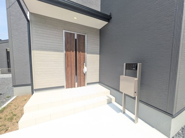 小美玉市羽鳥　13期　新築戸建て　4号棟の玄関|お洒落な玄関ドアと洗練された外壁デザイン。家の顔にふさわしい上質な佇まいで、ご家族やお客様を迎えます。