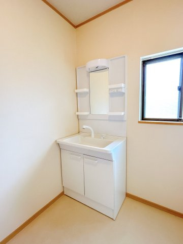 野木町南赤塚の独立洗面台|洗髪洗面化粧台を備えた洗面所。鏡の両側と洗面ボウル下に収納があり、洗面用品や日用品を整理できます。窓があり自然換気も可能です。