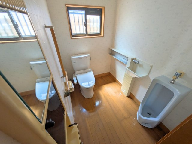 北条戸建てのトイレ|洋式と男性用の両方を備えた広々としたトイレ。独立した手洗い場や手すりもあり使いやすい仕様です。