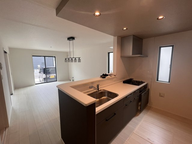 狭山市柏原 中古戸建｜駐車3台可・対面式キッチン、白を基調とした美しい室内、開放感あるLDKの邸宅の居間・リビング