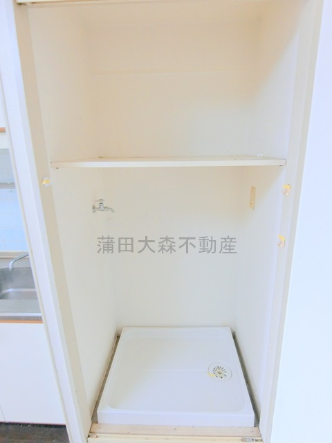 日興パレス羽田PARTⅡの設備|棚と扉付きの室内洗濯機置場