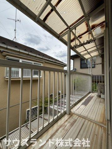 八王子市下恩方町のバルコニー|屋根付きの広々としたバルコニーです。急な雨でも洗濯物が濡れにくく、お出かけ中も安心ですね。ガーデニングの鉢植えを置いたり、ちょっとした気分転換に外の空気を吸ったりと、多目的に活用できる空間です。