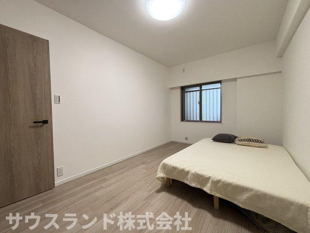 マクシスタワーズアーバンデュオの子供部屋|木目調の建具が空間になじむ、やさしい印象の洋室です。ベッドを置いても動線を確保しやすく、収納も備えているため室内を整えやすい間取り。主寝室としても使いやすい一室です。