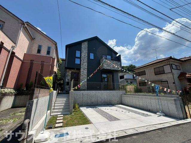 八王子市長沼町７期の外観|青空に映えるシックでモダンなデザインが特徴的な外観です！前面の道路も広々としており、お車の出し入れや駐車もスムーズに行えます。毎日の通勤やお出かけもストレスなく行える、生活に便利な住環境が魅力です♪
