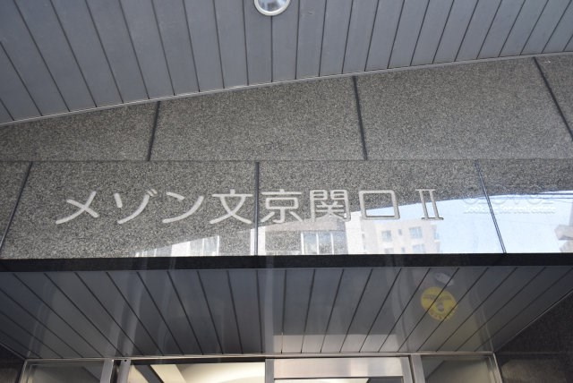 【現況写真】 | メゾン文京関口Ⅱ | エントランスに掲げられた、マンション名を示す館銘板。さほど激しく主張はしませんが、しっかりと掲示されています。～即日のご見学可能～　お問合せはお気軽にどうぞ。
