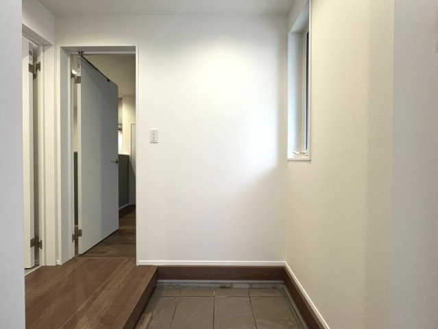 バババーババーババ。鶴見区の中でも住宅街の方です。シンプルな建売かと思いきやアクセントクロスや折り上げ天井でデザイン性も良き◎な【鶴見区馬場４丁目】新築戸建の玄関|落ち着いた玄関です