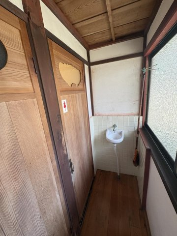京丹波町須知　蔵のある家の洗面所|左の扉は、母屋のトイレ（奥が男女用、手前が男子用）