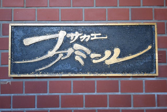 【現況写真】 | サカエファミール | エントランスに掲げられた、マンション名を示す館銘板。さほど激しく主張はしませんが、しっかりと掲示されています。～即日のご見学可能～　お問合せはお気軽にどうぞ。
