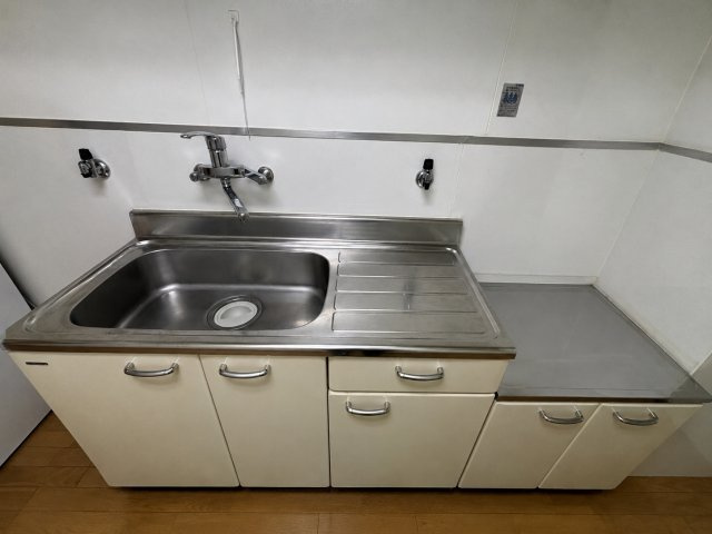 カサグランデ加美のキッチン|作業スペースを確保した使い勝手の良いキッチン。吊戸棚や下部収納もあり、調理器具や食器類を整理しやすい設計です。窓があるため、調理中の換気がしやすいのもうれしいポイントです◎