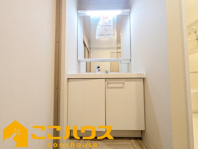 ライオンズマンション泊三丁目の独立洗面台|独立洗面台は収納豊富な三面鏡
