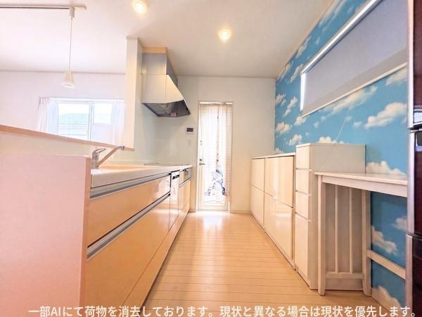 大字森町　戸建てのキッチン|明るい室内に収納力の高いキッチンが配置されています。壁面のデザインが特徴的で空間に開放感を与えています。作業スペースが広く動線も確保されています。