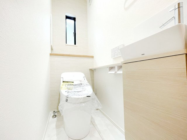 【トイレ】 | 富士見市大字水子　新築一戸建住宅　限定1棟（ふじみ野店） | 施工会社過去施工例：人感センサー、温水洗浄便座機能付き。洗面やカウンターのある便利なトイレです。