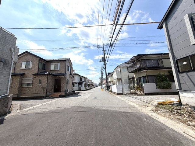 越谷市弥十郎１号棟　新築戸建の前面道路含む現地写真|足場が解体され外観がお披露目された現地。日当たりの良さとおしゃれな外観デザインが際立っています。