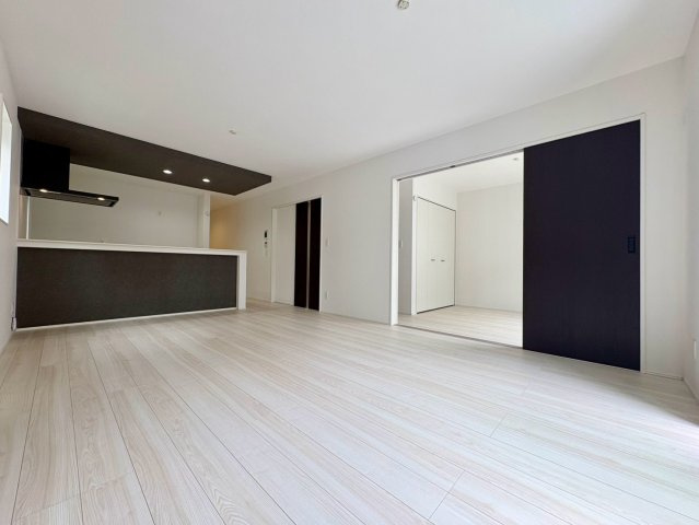 「南西角地の平屋」高知市瀬戸西町2期1棟　新築一戸建ての居間・リビング|光と風が心地よく抜ける広々リビング。木目調アクセントと間接照明が上質な家族の時間を演出します。